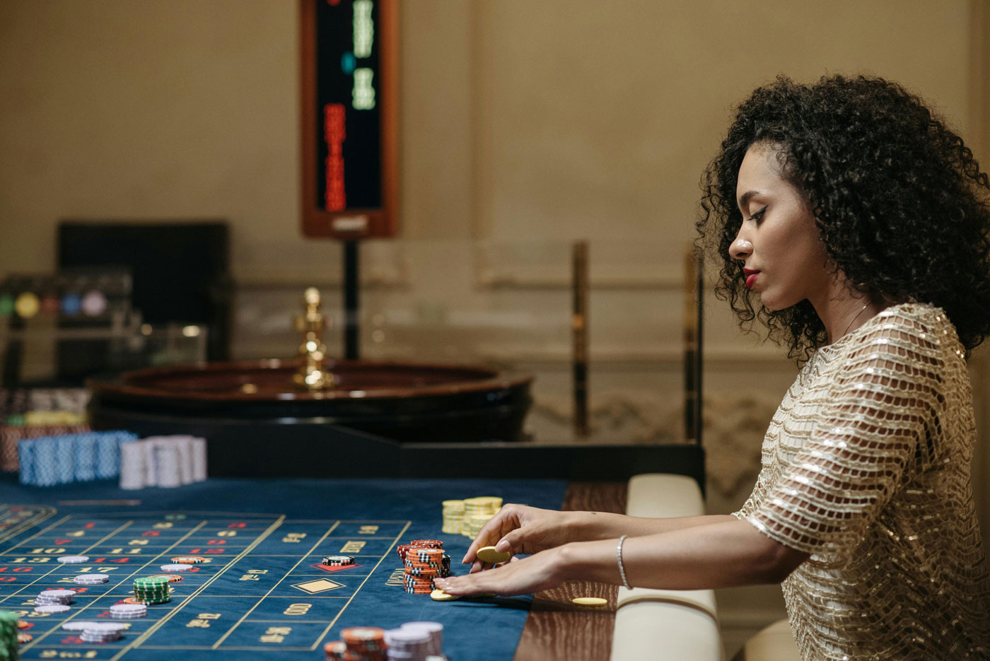 Woman placing chips on a casino table, illustrating the gamble of poor recruitment practices