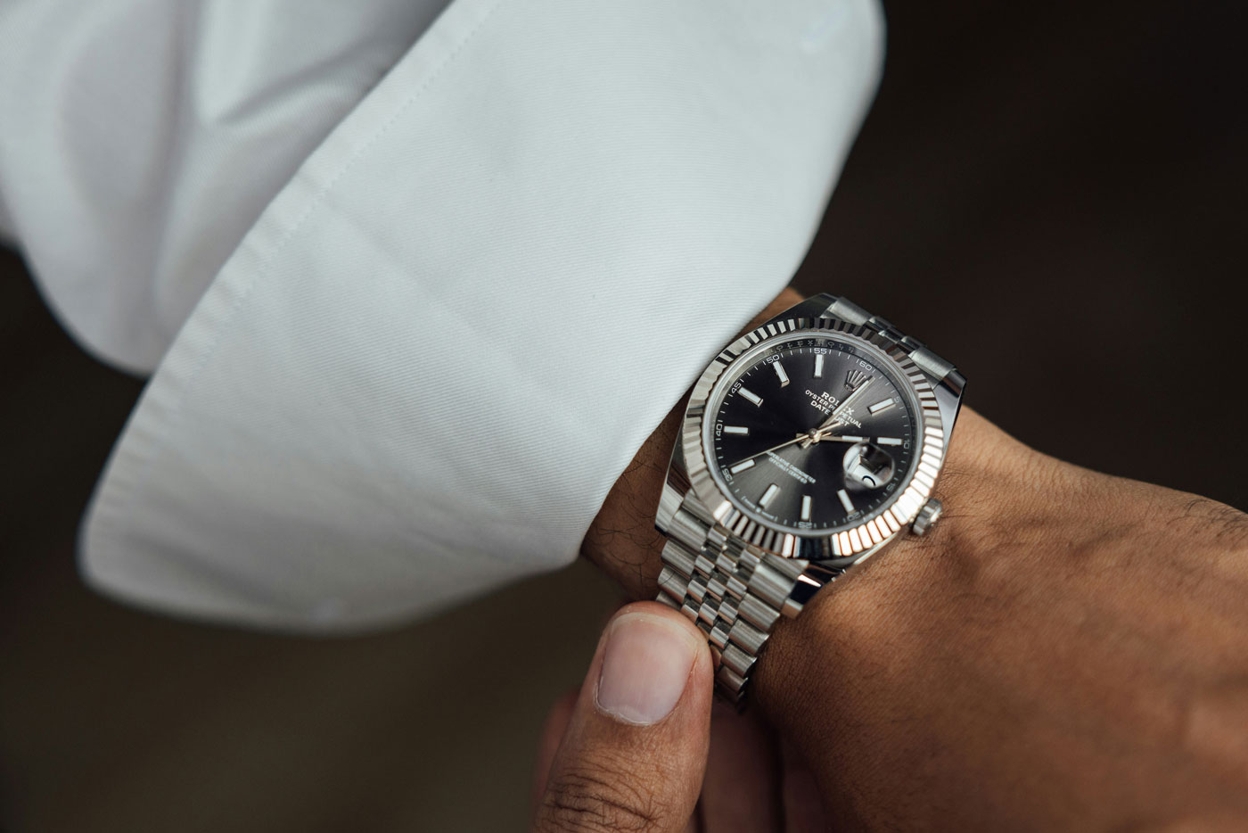 Luxury watch on wrist symbolising the time and care needed for quality hiring