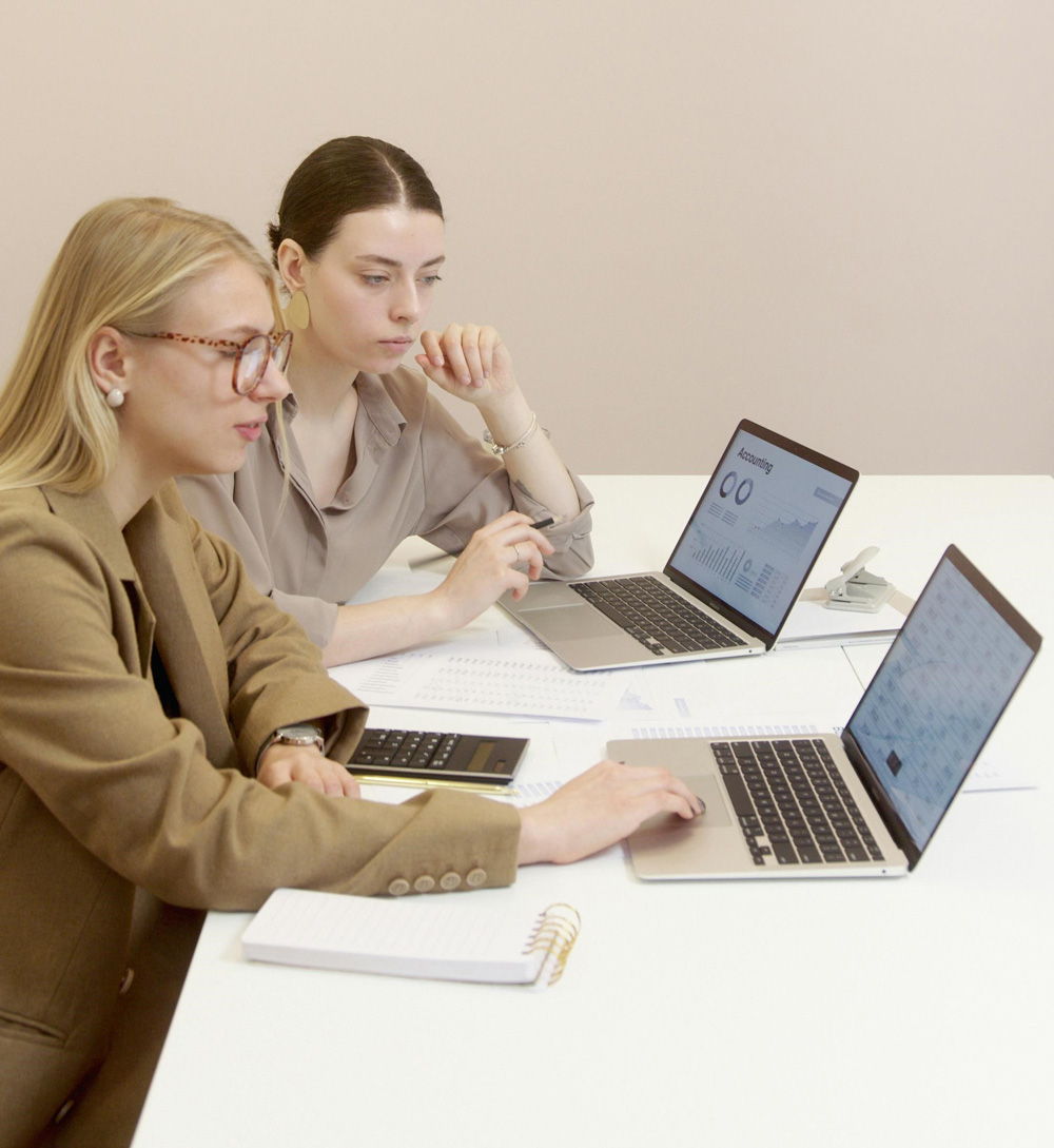 Two professionals discussing candidate fit during an EA and PA recruitment meeting
