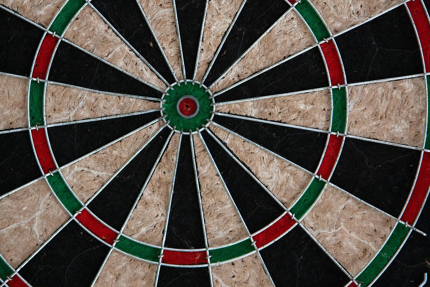 Close-up of a dartboard with the bullseye at the centre