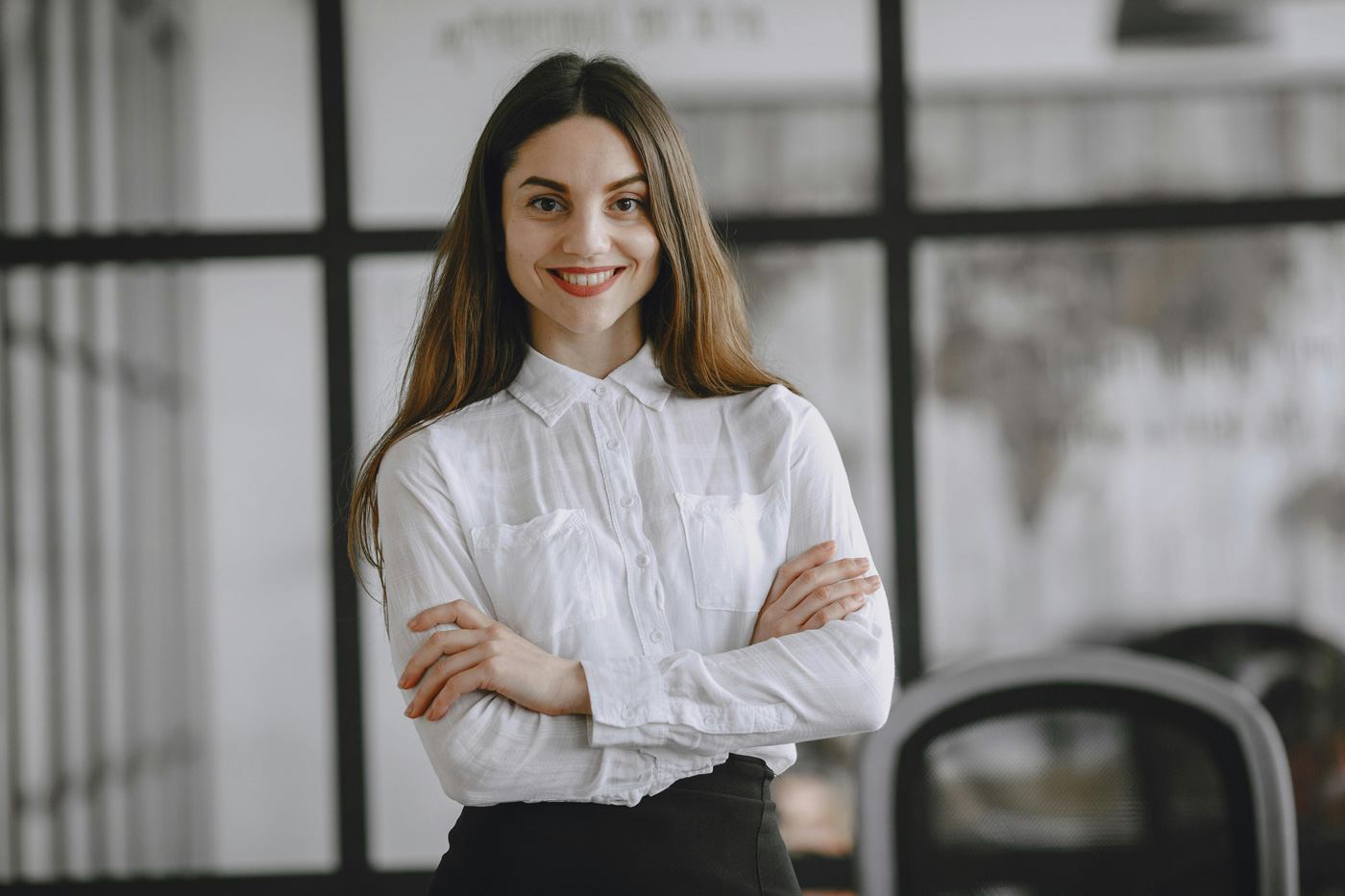 Professional woman standing confidently in a modern office