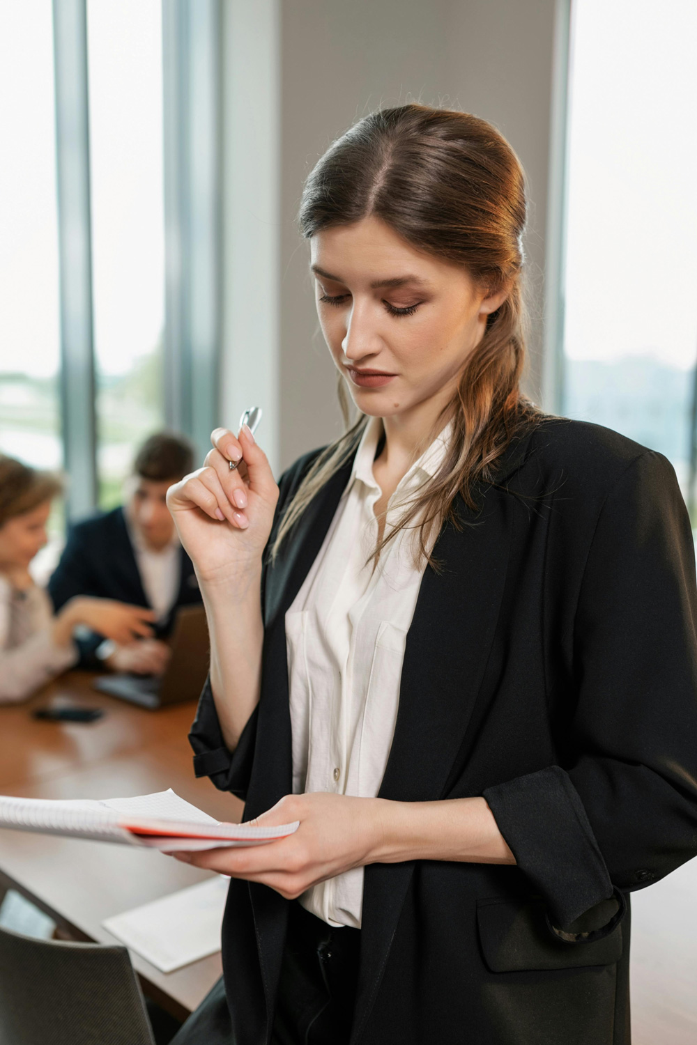 Businesswoman holding a notebook in an office meeting room