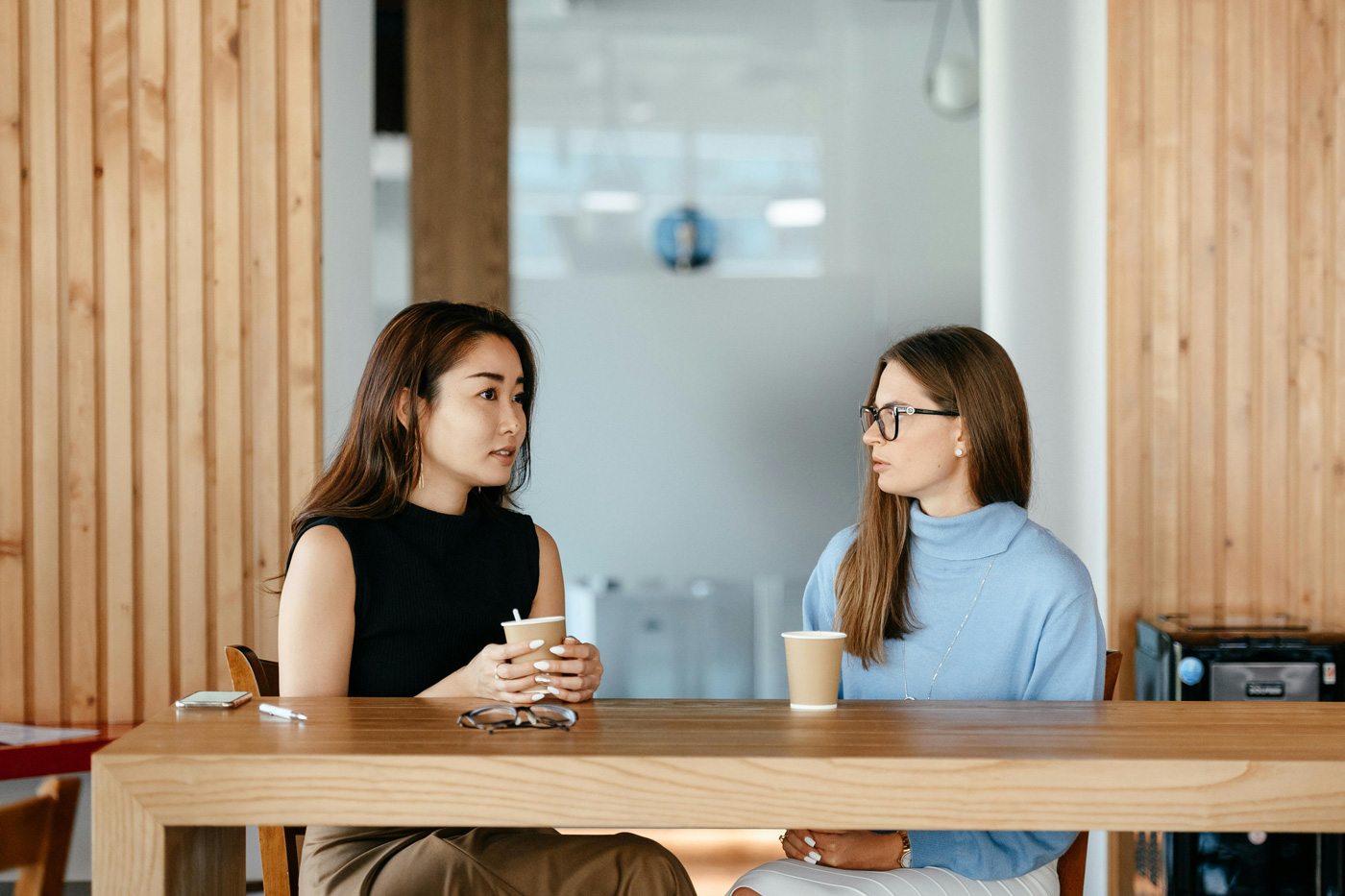 Two professionals discussing the evolving EA and PA role in the age of AI